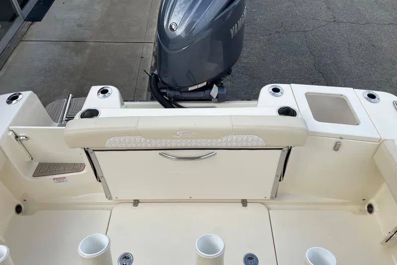 Slide: The Image of 2026 Scout 215 XSF boat with Yamaha outboard motor, featuring rod holders and seating. - 16