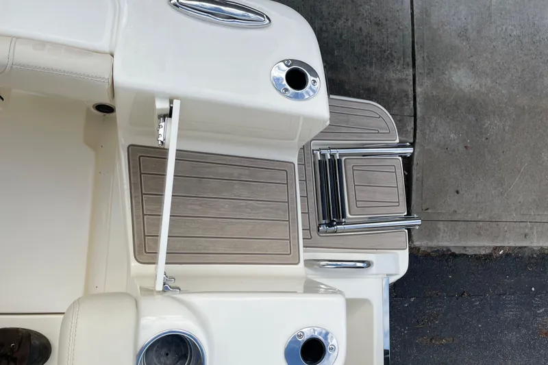 Slide: The Image of 2026 Scout 215 XSF boat deck with ladder and cup holders. - 18