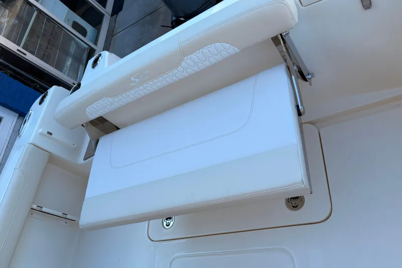 Slide: The Image of 2026 Scout 215 XSF boat with white cushioned seating and sleek design. - 6