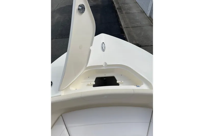 Slide: The Image of 2026 Scout 215 XSF boat with open storage compartment on deck. - 7