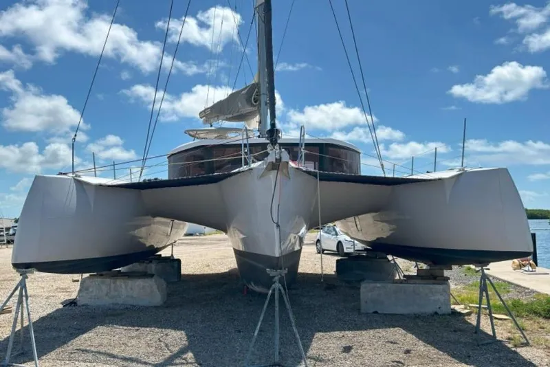 Slide: The Image of 2023 NEEL 47 trimaran on land, clear sky background. - 3