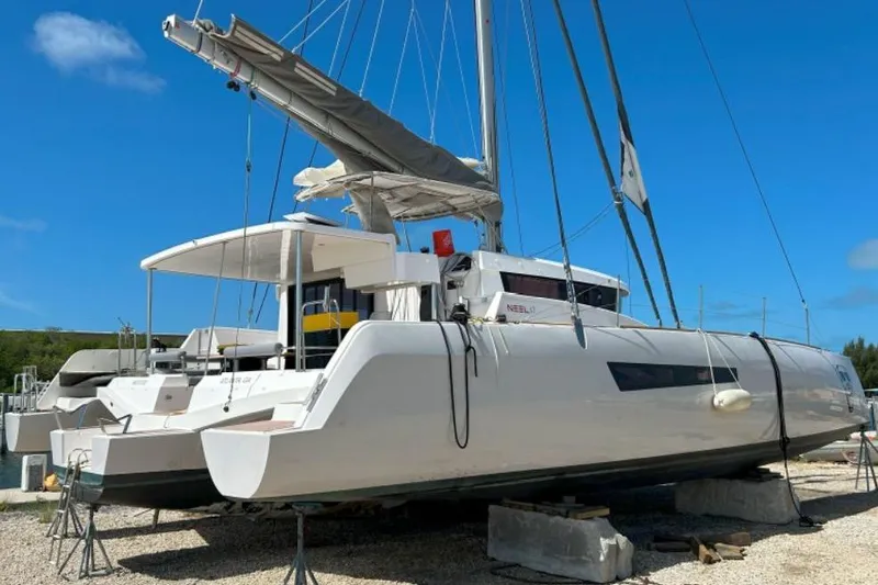 Slide: The Image of 2023 NEEL 47 trimaran sailboat on land, showcasing sleek design and modern features. - 4