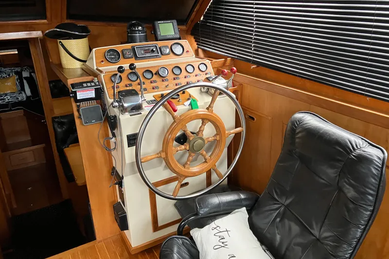 Slide: The Image of 1987 President 37 Sundeck yacht helm with wooden wheel and control panel. - 21