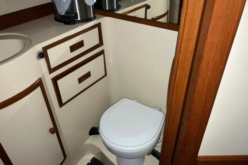 Slide: The Image of 1987 President 37 Sundeck yacht bathroom with toilet and wooden cabinetry. - 49