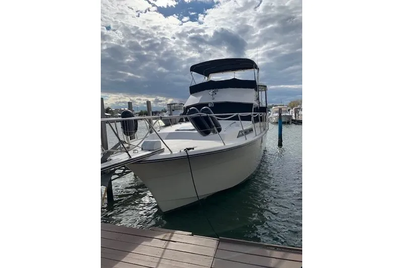 Slide: The Image of 1987 President 37 Sundeck yacht docked under cloudy sky. - 75