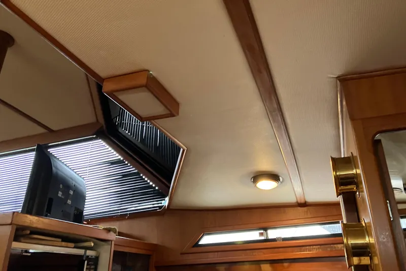 Slide: The Image of Interior of 1987 President 37 Sundeck yacht with wood paneling and modern lighting. - 55