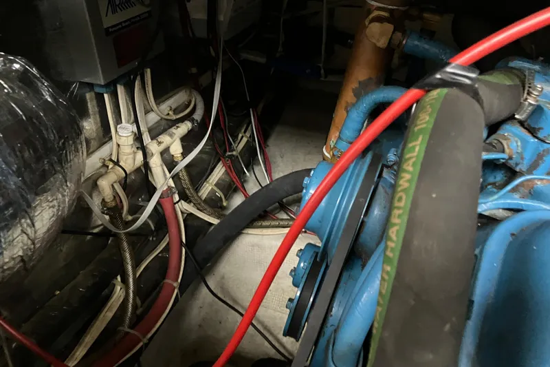 Slide: The Image of Engine room of 1987 President 37 Sundeck with visible hoses and wiring. - 67