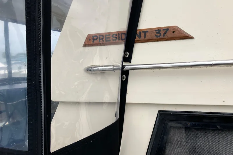 Slide: The Image of 1987 President 37 Sundeck boat detail with nameplate and window. - 10