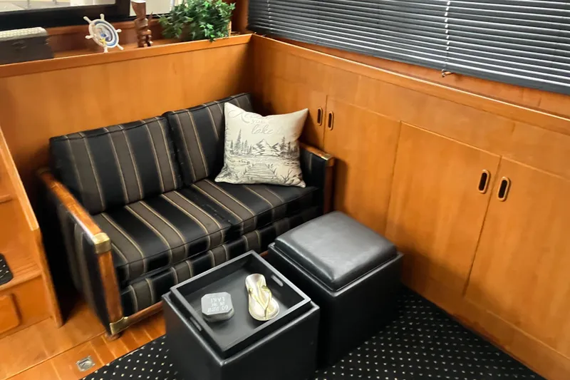 Slide: The Image of Cozy interior of 1987 President 37 Sundeck with striped sofa and decorative pillow. - 29