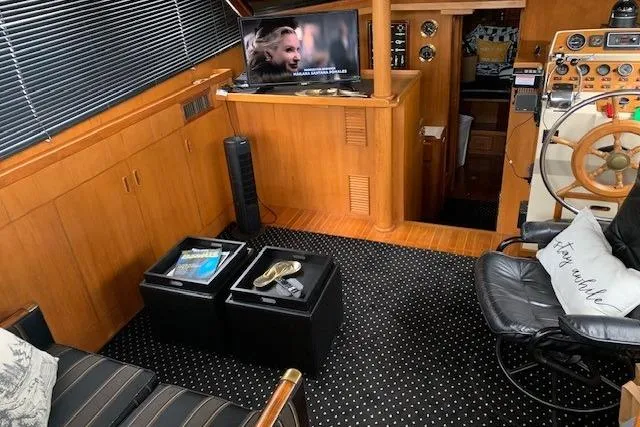 Slide: The Image of 1987 President 37 Sundeck interior with TV, seating, and nautical decor. - 19