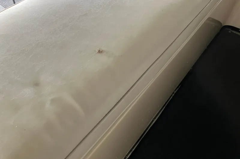 Slide: The Image of Close-up of 1987 President 37 Sundeck boat surface with visible wear. - 18