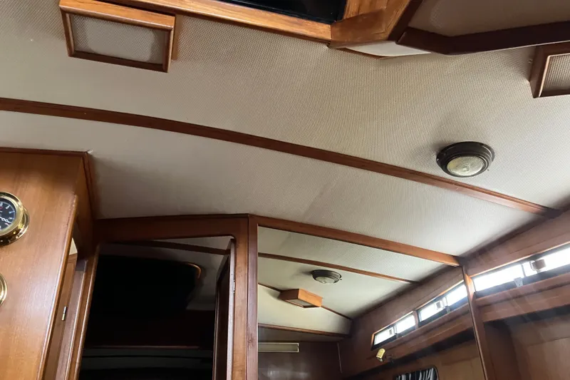 Slide: The Image of Interior view of 1987 President 37 Sundeck yacht with wooden accents and ceiling lights. - 40