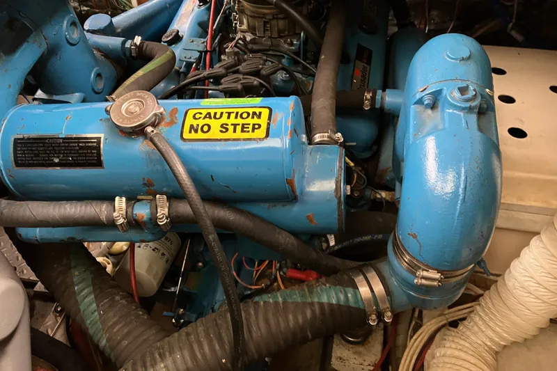 Slide: The Image of Engine compartment of a 1987 President 37 Sundeck boat with "Caution No Step" label. - 71