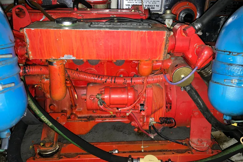 Slide: The Image of Engine of a 1987 President 37 Sundeck boat, featuring red and blue components. - 66