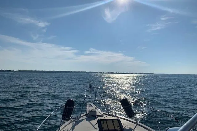 Slide: The Image of 1987 President 37 Sundeck yacht cruising on a sunny day with sparkling water. - 74