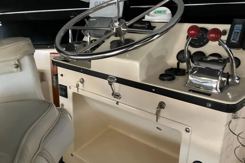 Slide: The Image of 1987 President 37 Sundeck helm with steering wheel and control panel. - 15