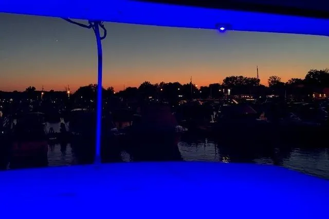Slide: The Image of 1987 President 37 Sundeck at sunset, blue-lit deck, serene waterfront view. - 76