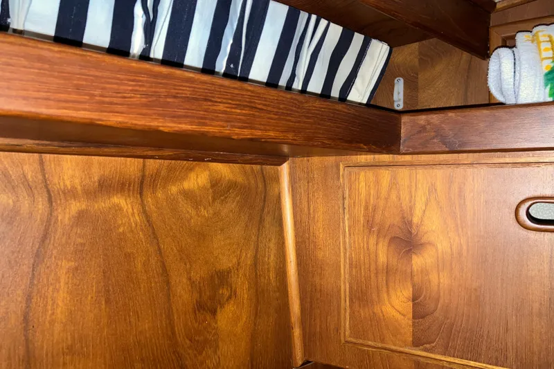Slide: The Image of Interior of 1987 President 37 Sundeck with wooden cabinetry and striped cushion. - 51