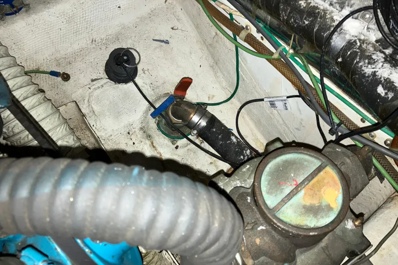 Slide: The Image of Engine compartment of a 1987 President 37 Sundeck boat, showing hoses and fittings. - 68