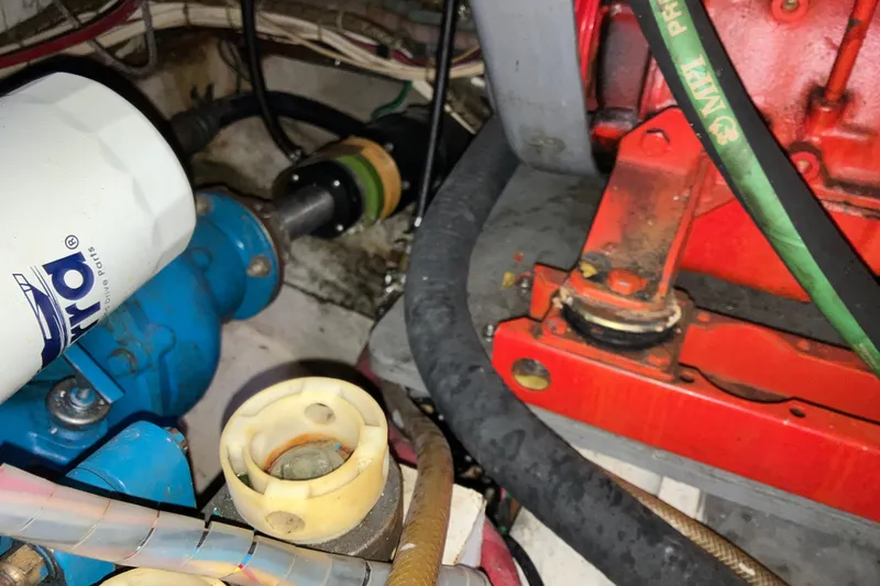 Slide: The Image of Engine compartment of a 1987 President 37 Sundeck boat with visible components. - 63