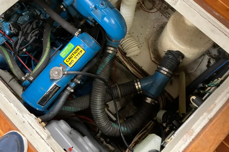 Slide: The Image of Engine compartment of 1987 President 37 Sundeck boat with visible hoses and components. - 69
