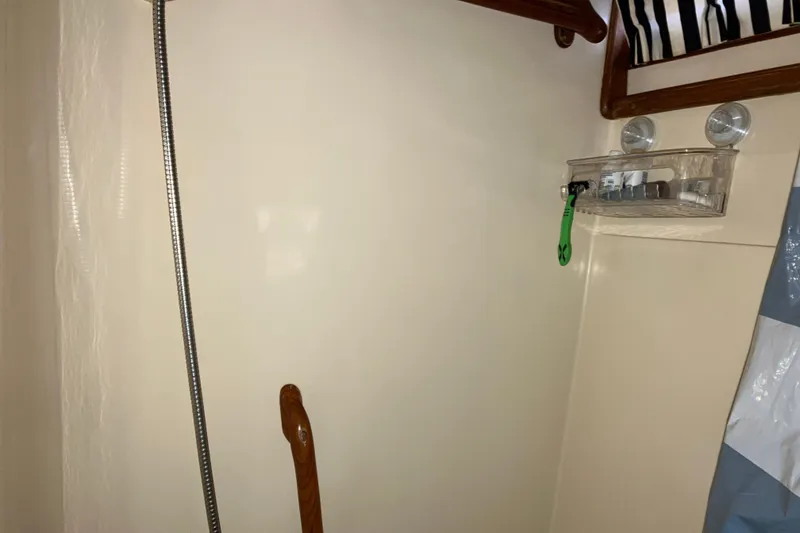 Slide: The Image of 1987 President 37 Sundeck interior with shower area and storage shelf. - 58