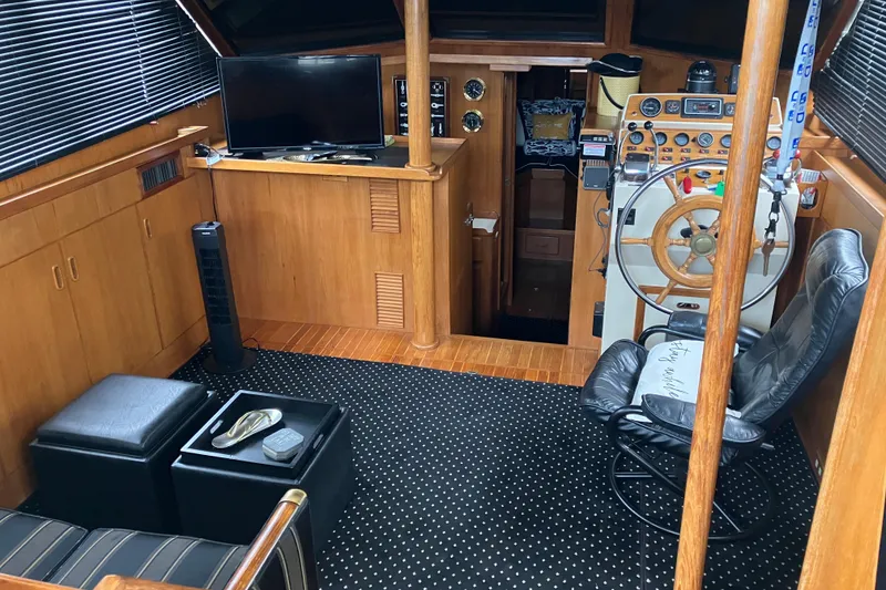 Slide: The Image of Interior of 1987 President 37 Sundeck yacht with helm, seating, and TV. - 20
