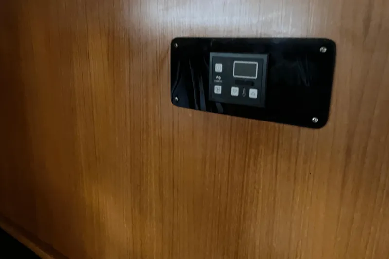 Slide: The Image of Control panel on wooden interior of 1987 President 37 Sundeck yacht. - 39