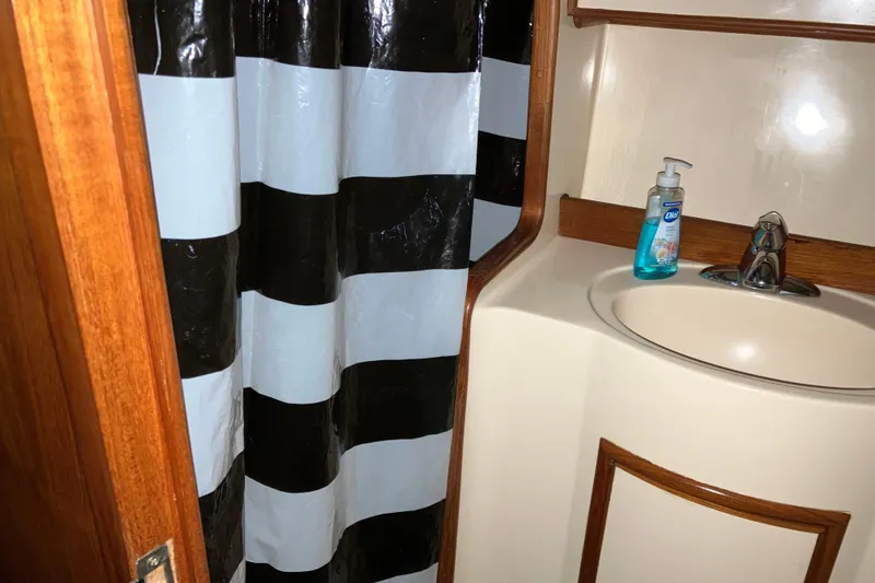Slide: The Image of Bathroom interior of 1987 President 37 Sundeck yacht with striped shower curtain. - 50