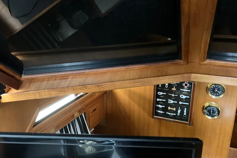 Slide: The Image of Interior of 1987 President 37 Sundeck yacht with wooden paneling and gauges. - 30