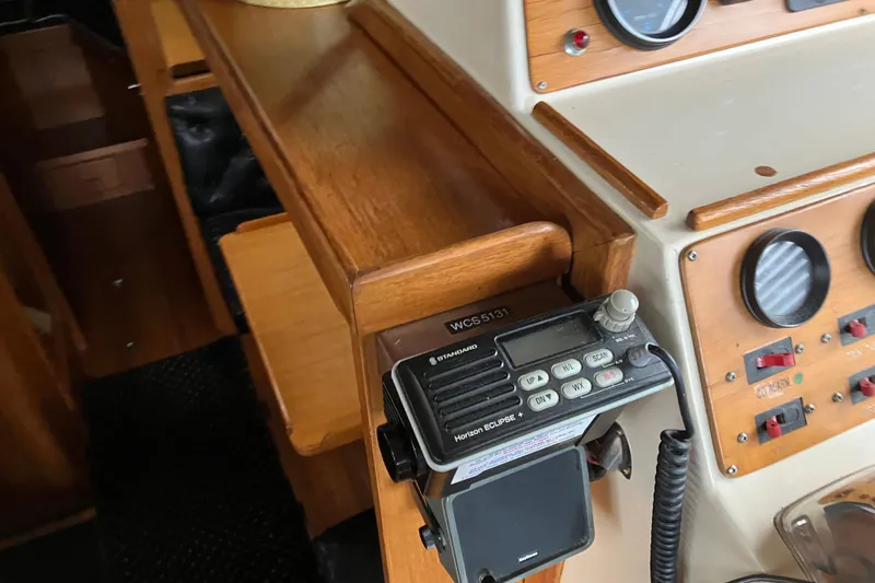 Slide: The Image of 1987 President 37 Sundeck yacht interior with radio and control panel. - 16