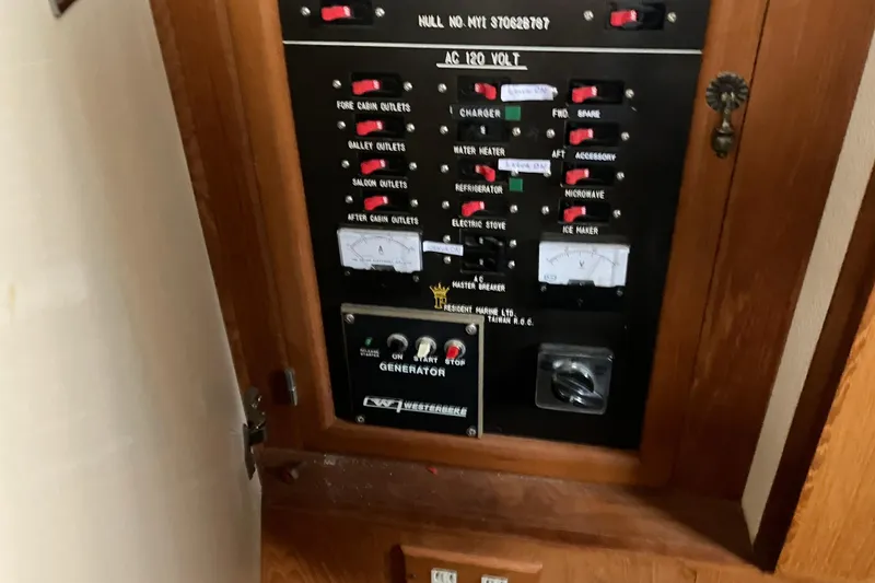 Slide: The Image of Electrical panel of a 1987 President 37 Sundeck boat, featuring various switches and controls. - 60