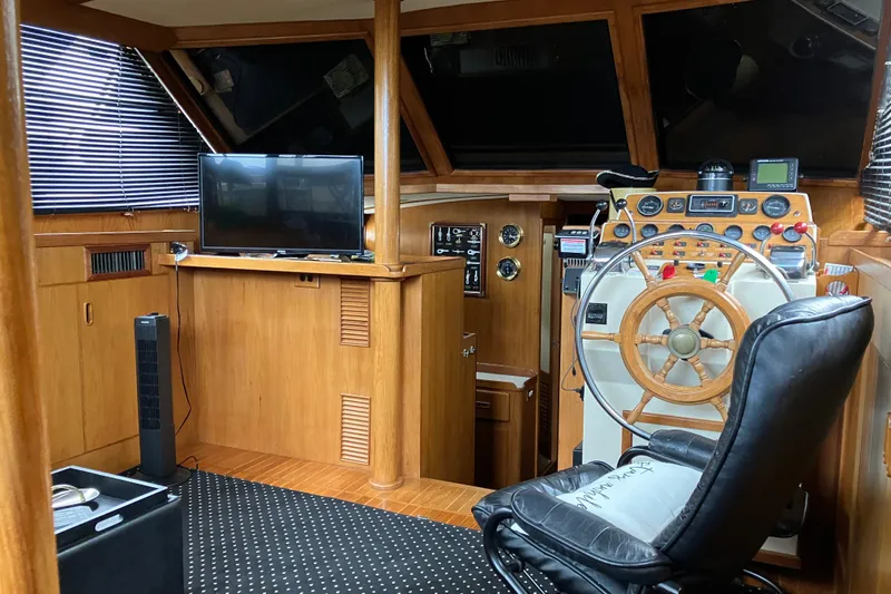 Slide: The Image of 1987 President 37 Sundeck yacht interior with helm, TV, and leather chair. - 24