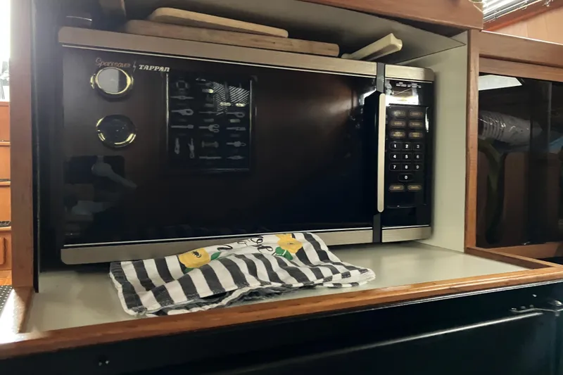 Slide: The Image of Microwave in 1987 President 37 Sundeck yacht kitchen with striped towel. - 38