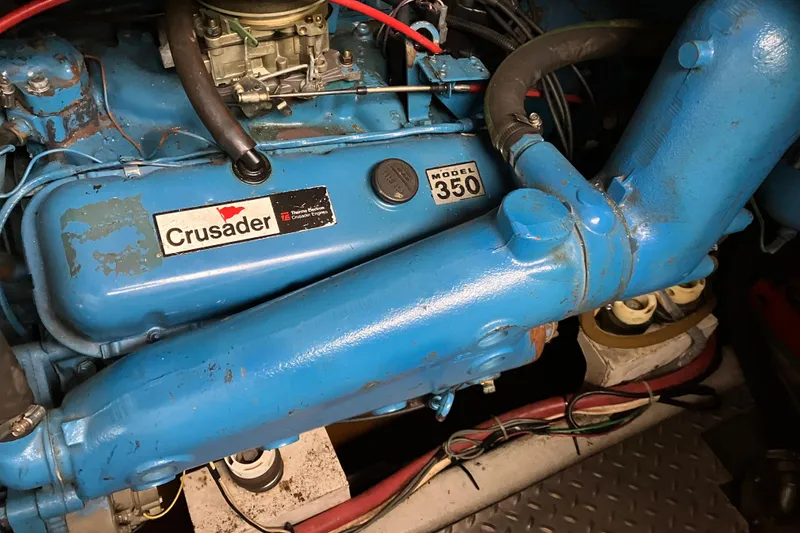 Slide: The Image of 1987 President 37 Sundeck engine, Crusader Model 350, blue with visible components. - 62
