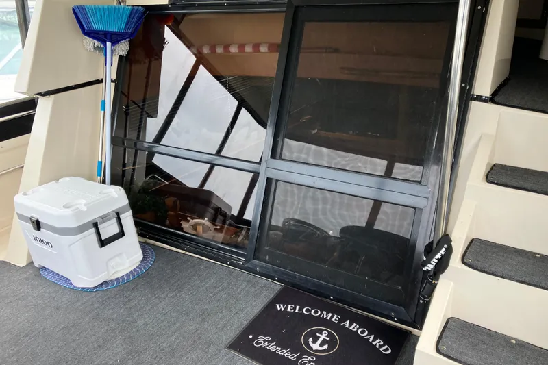 Slide: The Image of 1987 President 37 Sundeck yacht entrance with cooler, broom, and welcome mat. - 5