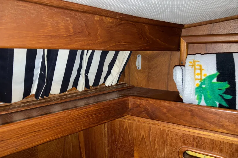 Slide: The Image of 1987 President 37 Sundeck interior with striped cushions and wooden cabinetry. - 52