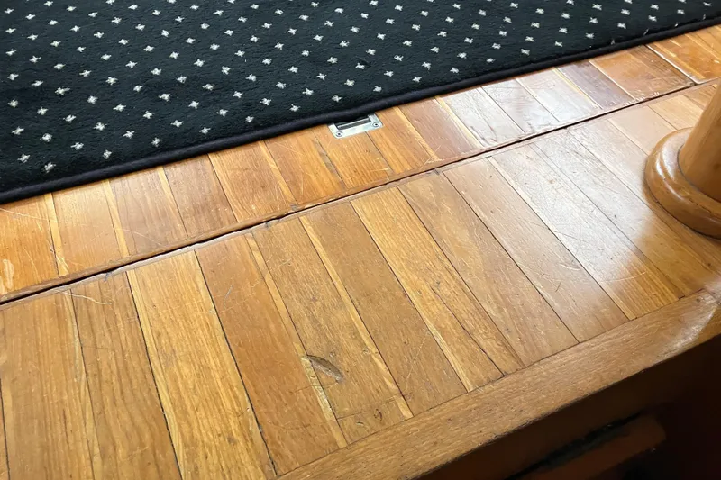 Slide: The Image of Wooden deck flooring with patterned carpet on a 1987 President 37 Sundeck yacht. - 44