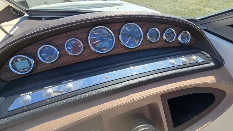 Slide: The Image of Dashboard of a 2013 Cobalt 210 boat with multiple gauges and controls. - 12
