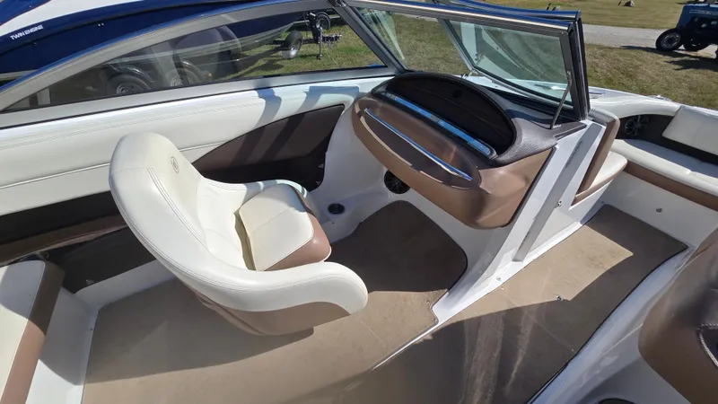 Slide: The Image of Interior of a 2013 Cobalt 210 boat with beige and white seating. - 13