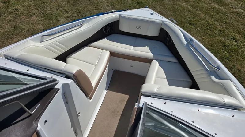 Slide: The Image of 2013 Cobalt 210 boat interior with white leather seating and stainless steel accents. - 14