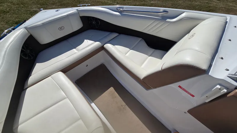 Slide: The Image of 2013 Cobalt 210 boat interior with white leather seating and spacious layout. - 15