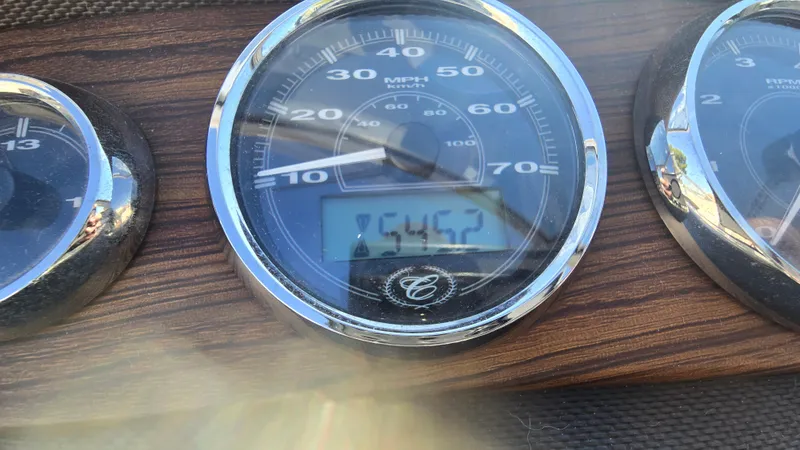 Slide: The Image of Speedometer of a 2013 Cobalt 210 boat showing 45.2 MPH on a wooden dashboard. - 16