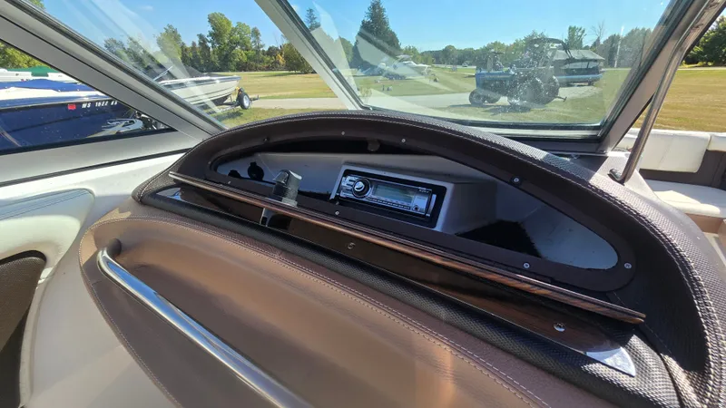 Slide: The Image of Interior of a 2013 Cobalt 210 boat showing dashboard and stereo system. - 17