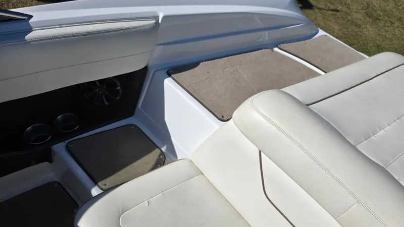 Slide: The Image of Interior of a 2013 Cobalt 210 boat with white leather seats and cup holders. - 23