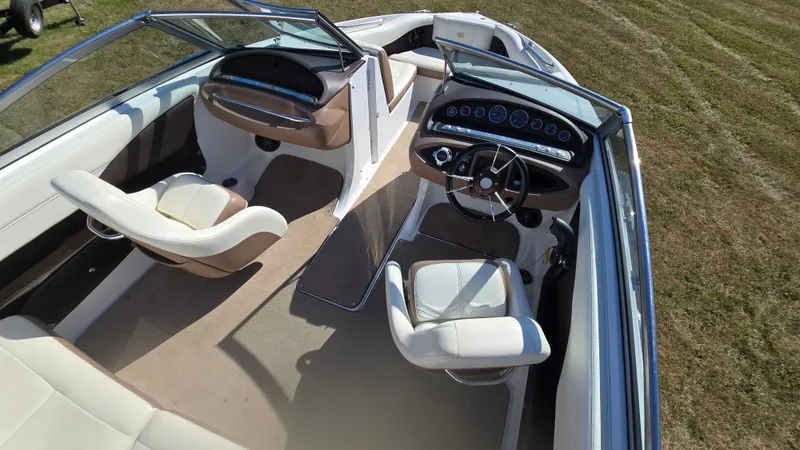 Slide: The Image of Interior of a 2013 Cobalt 210 boat with beige and white seating. - 9