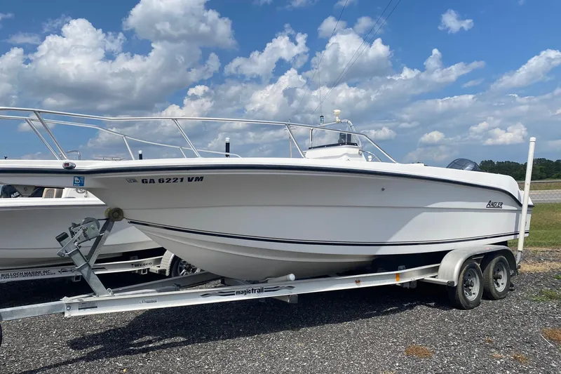 Slide: The Image of 2001 Angler 2100 Center Console boat on trailer under a cloudy sky. - 0