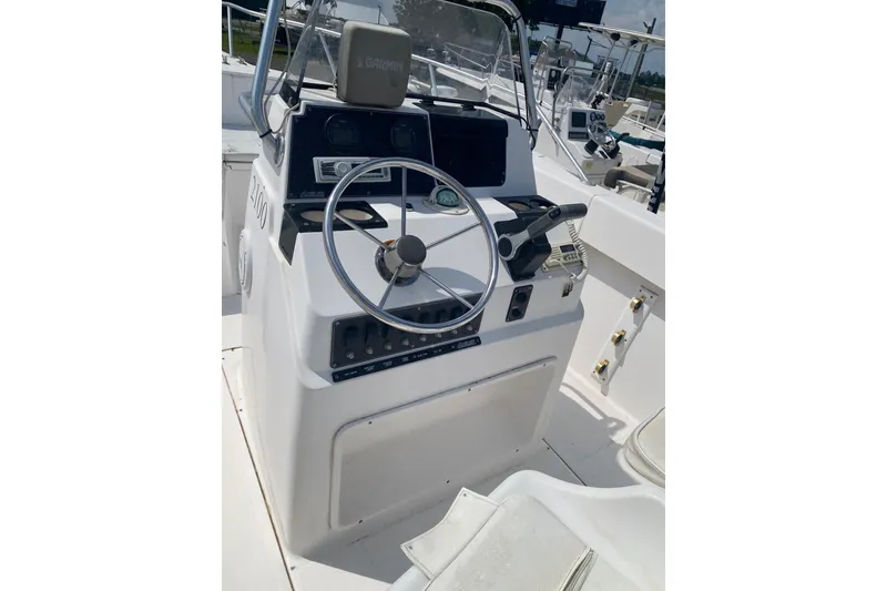 Slide: The Image of 2001 Angler 2100 Center Console boat dashboard with steering wheel and controls. - 3