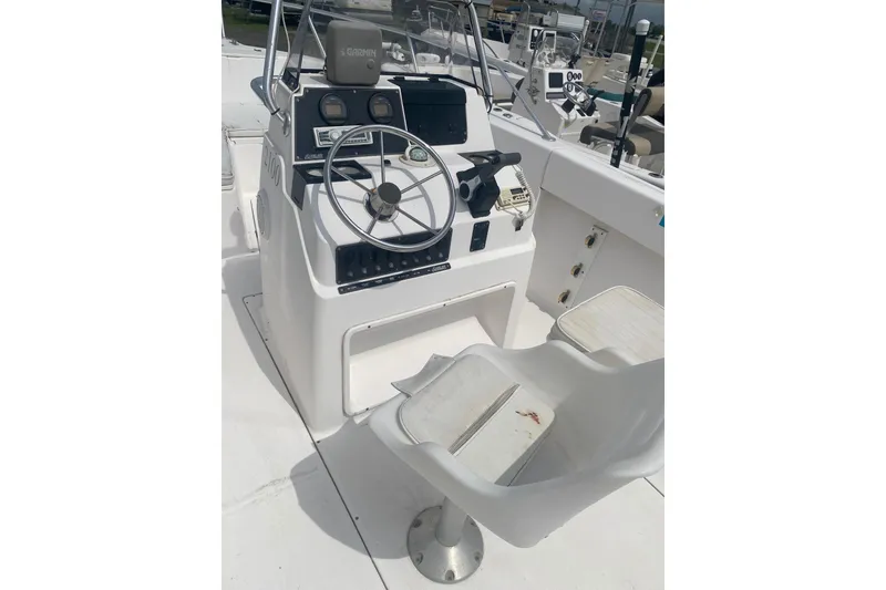 Slide: The Image of 2001 Angler 2100 Center Console boat interior with steering wheel and controls. - 4