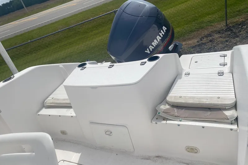 Slide: The Image of 2001 Angler 2100 Center Console boat with Yamaha outboard motor, white seating, and storage compartments. - 5